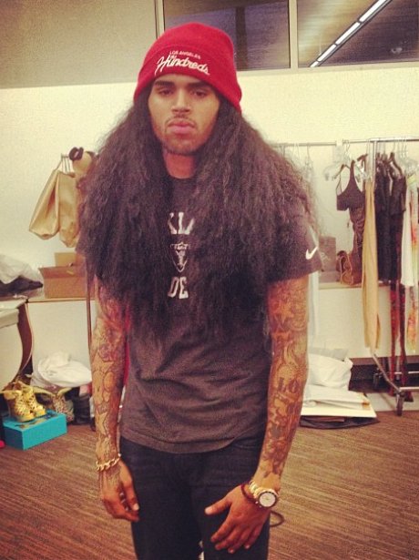 Chris Brown wearing a long haired wig.