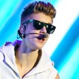 Justin Bieber shows off new owl tattoo on stage